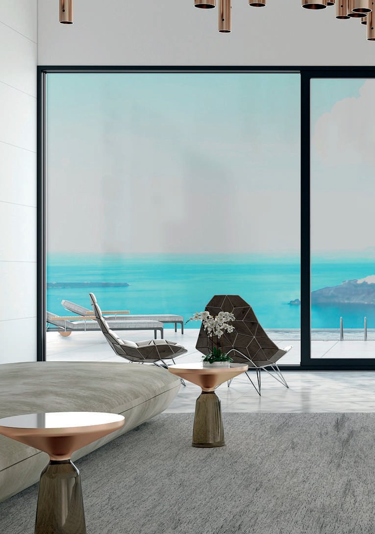 Lift-and-slide glazed wall in a lounge opening to a sea-view terrace